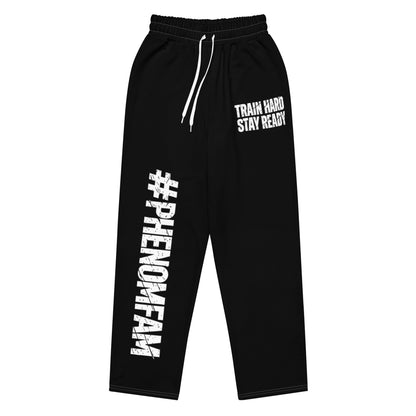 Black sweatpants with white drawstrings, featuring 'PHENOMFAM' printed vertically on the left leg and 'TRAIN HARD STAY READY' on the right leg, shown against a plain white background.