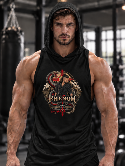 A muscular man in a black gym setting wearing a black sleeveless hooded tank top with a detailed red, gold, and white chest graphic that reads 'PHENOM'.