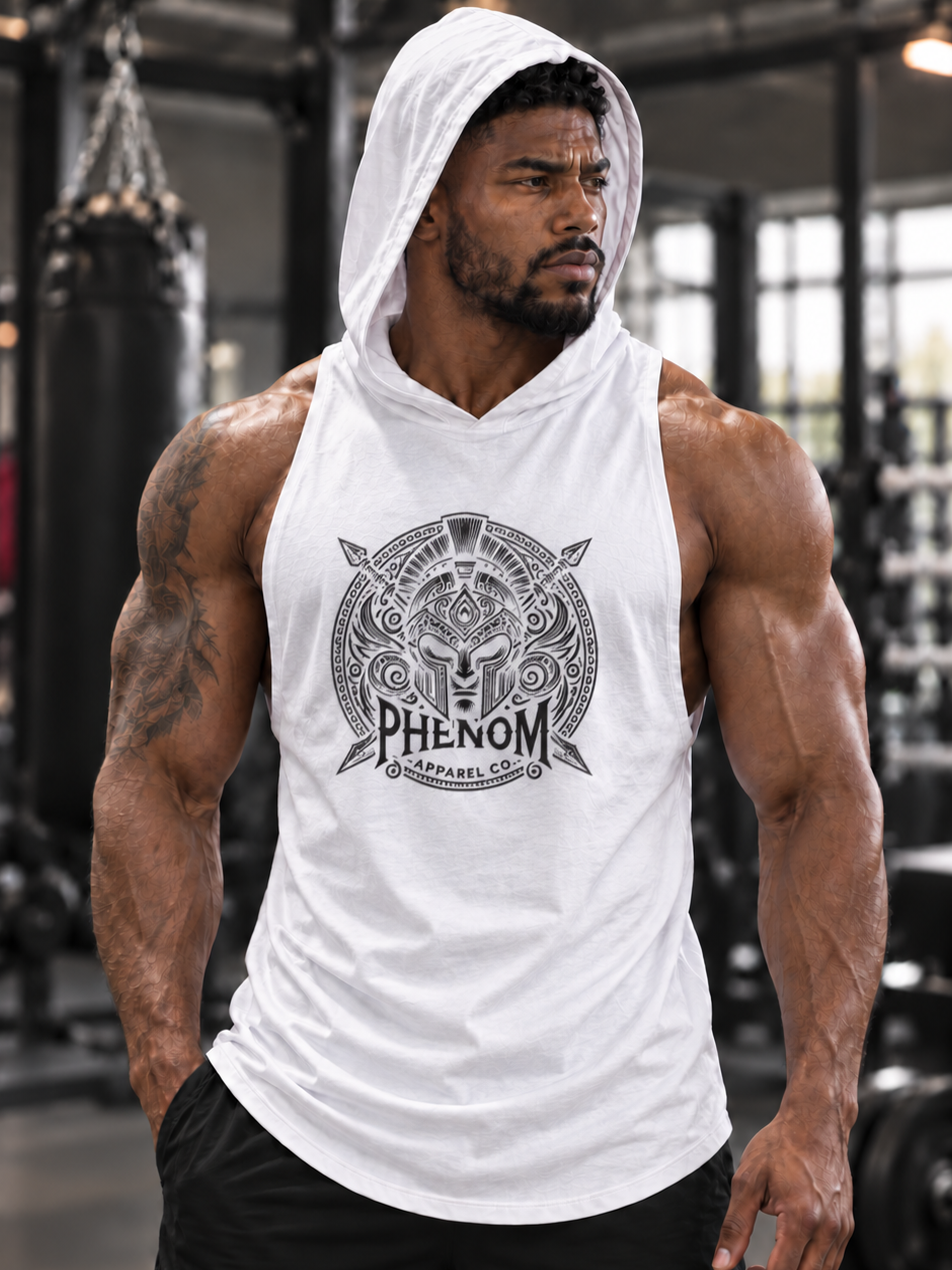 A muscular man in a gym wearing a white sleeveless hooded tank top with a black circular graphic that reads 'PHENOM SUPPLEMENTS' and black athletic shorts.